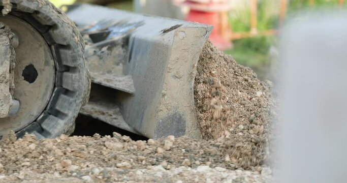 Bulldozer Rows Gravel Sand In The Bucket During Road Construction In Leiria, Portugal. - Close Up Shot