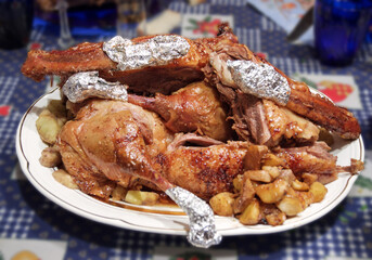 oven-roasted goose with apples, cut into chunks. celebratory dish served to the table on an elegant porcelain plate. with clipping path