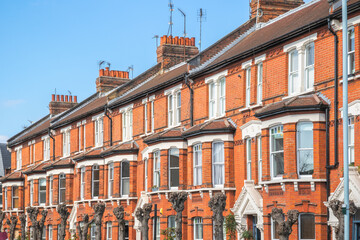 Fototapeta na wymiar Row of identical traditional English red brick terraced houses around Crouch End area in London