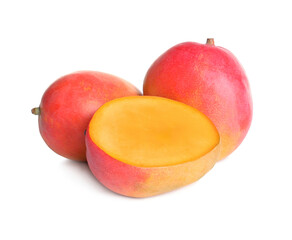 Delicious whole and cut mangoes on white background