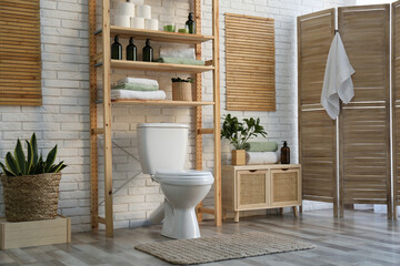 Stylish bathroom interior with toilet bowl and other essentials