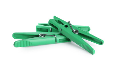 Bright green plastic clothespins on white background