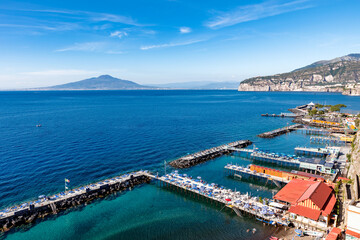 The seaside resort of the marina of Sorrento on a warm spring day with Vesuvius and the coast in...