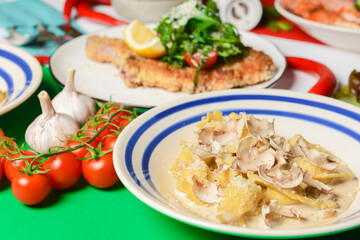 Italian food on Italian flag background, top view, flat lay. Pasta, shrimps, cream soup with pumpkin seeds.