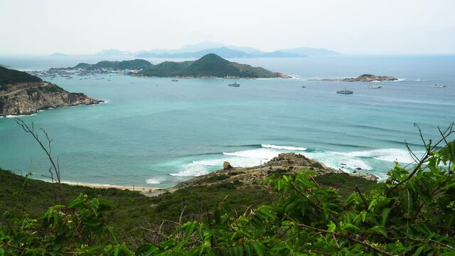 Aerial wide shot showing beautiful ocean landscape with bay,beach and mountains in background. Vietnam,Asia.