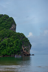 Fototapeta premium Colorful Boat Moored near Tropical Island