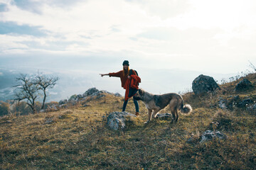 woman hiker with dog on nature travel mountains landscape fun
