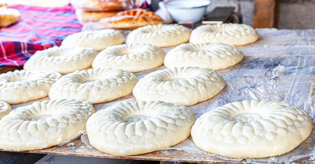 Fototapeta na wymiar Traditional uzbek round flat bread is preparing to put in the tandyr