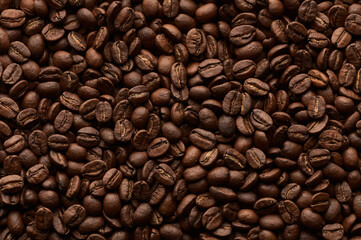 Roasted coffee beans background. Close up top view.