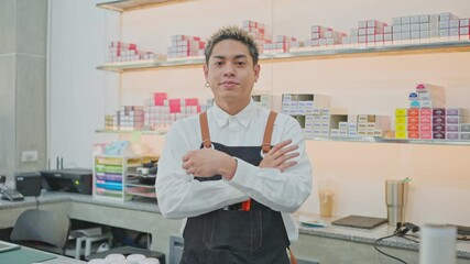 Portrait of Asian male hairdresser crossing arms with confident face.