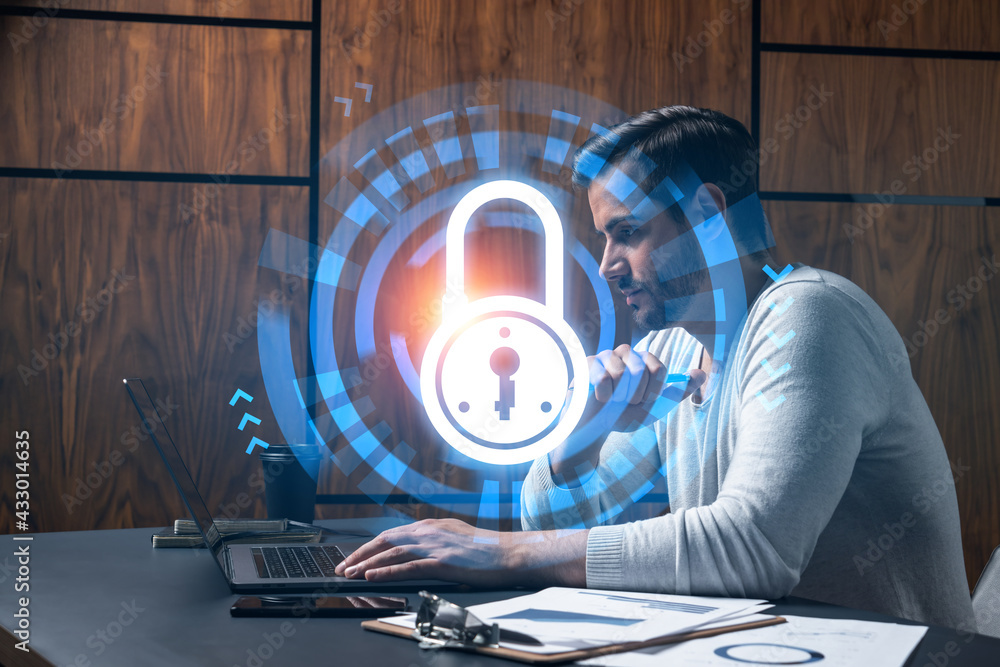 Poster a serious caucasian programmer in casual wears, using laptop to develop a new security system to pro