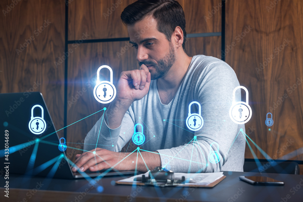Poster a serious caucasian programmer in casual wears, using laptop to develop a new security system to pro