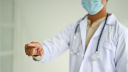 Cropped shot of A doctor in a lab uniform pointing to the front, Medical concepts.