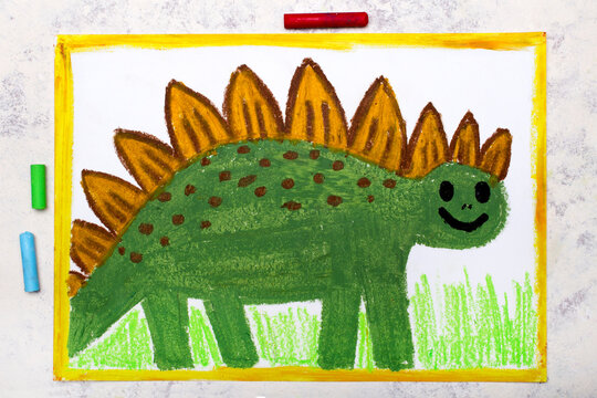 Photo of colorful drawing: Smiling dinosaur. Green weird stegosaurus.