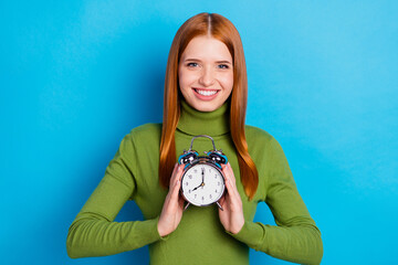 Photo portrait of young girl showing alarm watch time management isolated on vivid blue color...