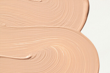 Liquid make up foundation or concealer smear close up. Beauty cosmetic abstract