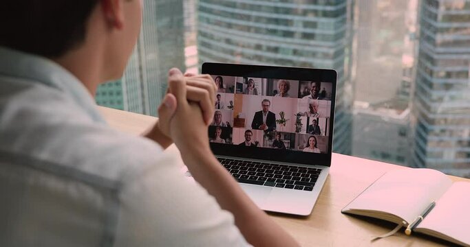 Over businessman shoulder laptop screen view multi ethnic business partners involved group in negotiations by videoconference. Solve business remotely use easy comfort method, video call event concept
