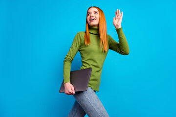 Profile photo of nice satisfied lady hold laptop look empty space arm palm wave isolated on blue color background © deagreez