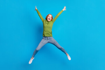 Fototapeta premium Full length body size view of pretty carefree cheerful girl jumping having fun good mood isolated over bright blue color background
