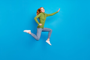 Fototapeta na wymiar Full length body size view of attractive glad cheerful girl jumping running isolated over bright blue color background