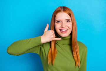 Photo of positive orange hair lady show hand telephone wear green sweater isolated on blue color...