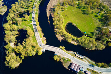Car moving on bridge in europe small town, aerial view
