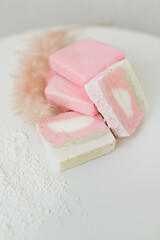 handmade soap of pink color lies on a white background