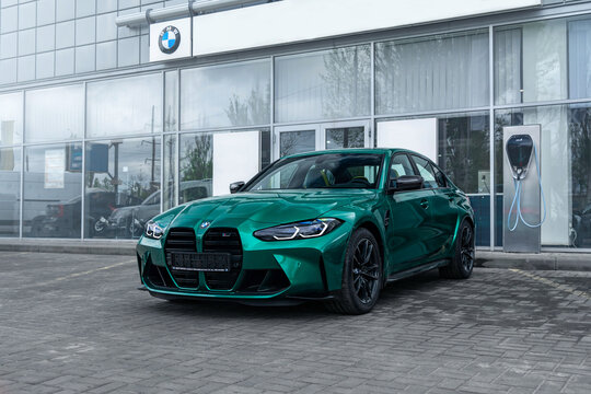 Brand new BMW M3 G80 in a green color on the dealership. Kherson, Ukraine - May 2021.