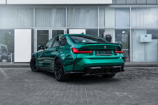 Brand new BMW M3 G80 in a green color on the dealership. Kherson, Ukraine - May 2021.
