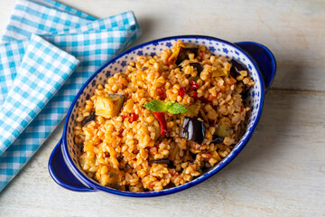 Traditional delicious Turkish food; Bulgur pilaf with eggplant and vegetables. (Turkish name; Patlicanli bulgur pilavi)