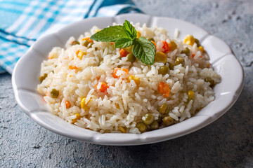 Delicious vegetable rice pilaf with green peas, carrots and sweet corn