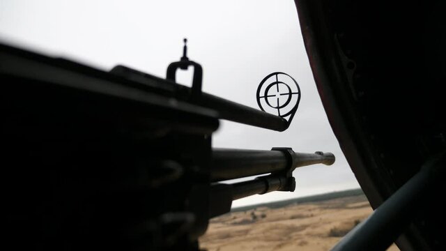 Up-to-date machine gun front sight shivering in a patrolling helicopter in early spring