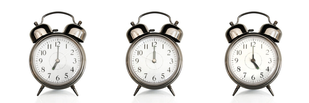 Old vintage alarm clocks at different time of the days isolated on panoramic white background. Morning, noon,afternoon,evening concept