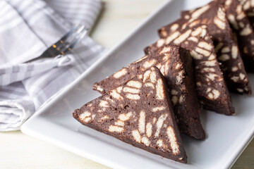 Delicious mosaic chocolate and biscuit cake served in a white plate (Turkish name; Mozaik pasta or Mozaik kek)