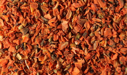 Dried and chopped carrot pieces pile background and texture, top view