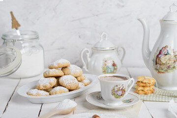 My sister spill the milk on chocolate hot drink to prepare breakfast with Eid Cookies which is called Kahk.
