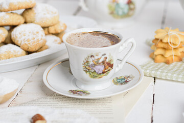 My sister spill the milk on chocolate hot drink to prepare breakfast with Eid Cookies which is called Kahk.
