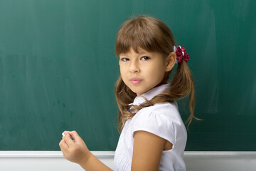 Pretty girl posing at blackboard