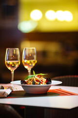 Gourmet seafood pasta with white wine in a restaurant