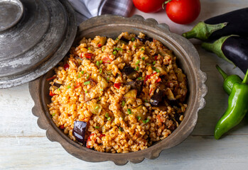 Traditional delicious Turkish food; Bulgur pilaf with eggplant and vegetables. (Turkish name;...