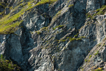 A fragment of a rock close-up. Mountain background, natural texture