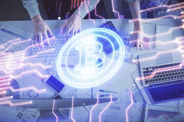Double exposure of man and woman working together and crypto theme hologram drawing. Computer background. Blockchain concept. Top View.