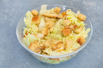 Caesar salad with toast, lettuce and grilled chicken breast and cheese