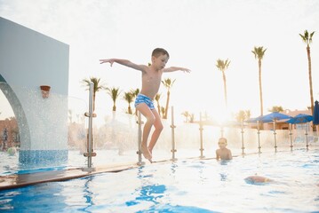 Boy jumping in swimming pool