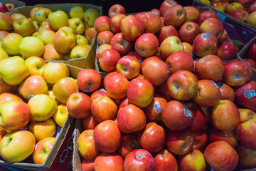 Baskets of fresh and succulent apples for sale in supermarkets