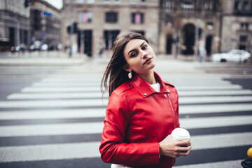 Fototapeta premium Wistful female with coffee on street