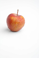 Fresh red apple with drops isolated on white background.
