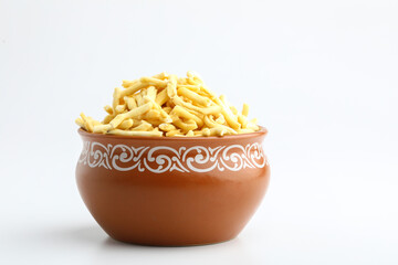 Bhavnagari Gathiya is a very popular Gujarati snack, brown bowl on white background