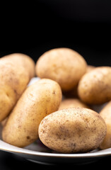 Fresh potato lies on a plate