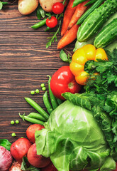 Healthy food. Assortment of fresh summer organic vegetables and herbs on wooden table background